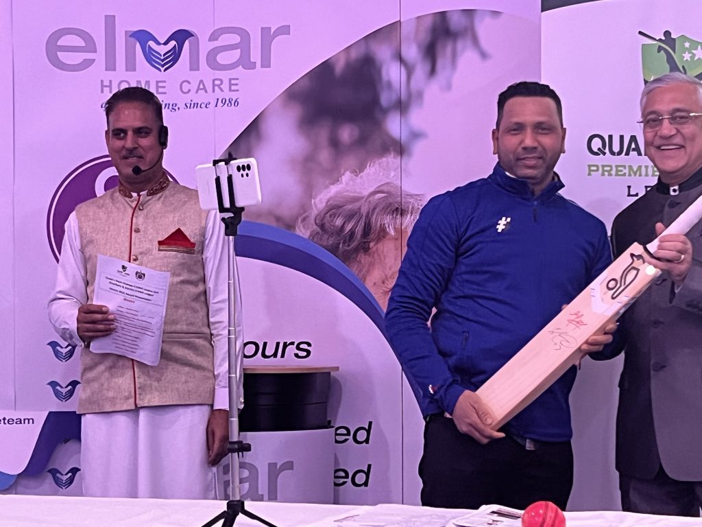 Kamlesh Patel presenting 2nd raffle prize Signed bat by Harris Rauf and Shadab Khan
